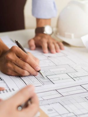 Close-up of an engineer planning a hand-drawn design. with architect equipment Architects talking at the table Teamwork and workflow concepts